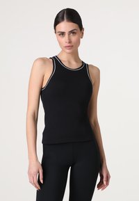 Canotta nera senza maniche con bordi bianchi a contrasto, design aderente, texture a coste e scollatura rotonda. Adatta per l'abbigliamento casual o per l'uso attivo.