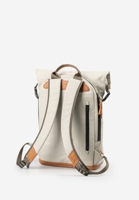 Light gray roll-top backpack with brown leather accents, adjustable straps, side zipper pocket, and top handle. Smooth fabric texture.