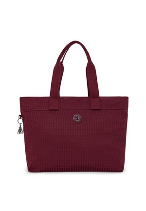 Burgundy tote bag with textured surface, dual fabric handles, rectangular shape, branded metal logo, and a charm accent on the zipper.