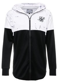 Svart och vit zip-huvtröja med huva, med ett marmormönster på övre delen och ribbade ärmslut. Logotyp på vänster bröstområde.