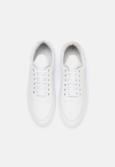 White leather sneakers with a rounded shape, flat laces, and metal eyelets. The interior features a soft lining, and branding is embossed on the tongue.
