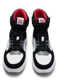 High-top sneakers featuring a black, white, and grey color scheme with a textured fabric upper, padded collar, and contrasting red lining.