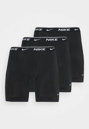 Schwarze Baumwoll-Boxershorts, Dreierpack. Mit einem schwarzen Bund und weißem "Nike"-Logo. Glatte Textur, mittellanges Design.