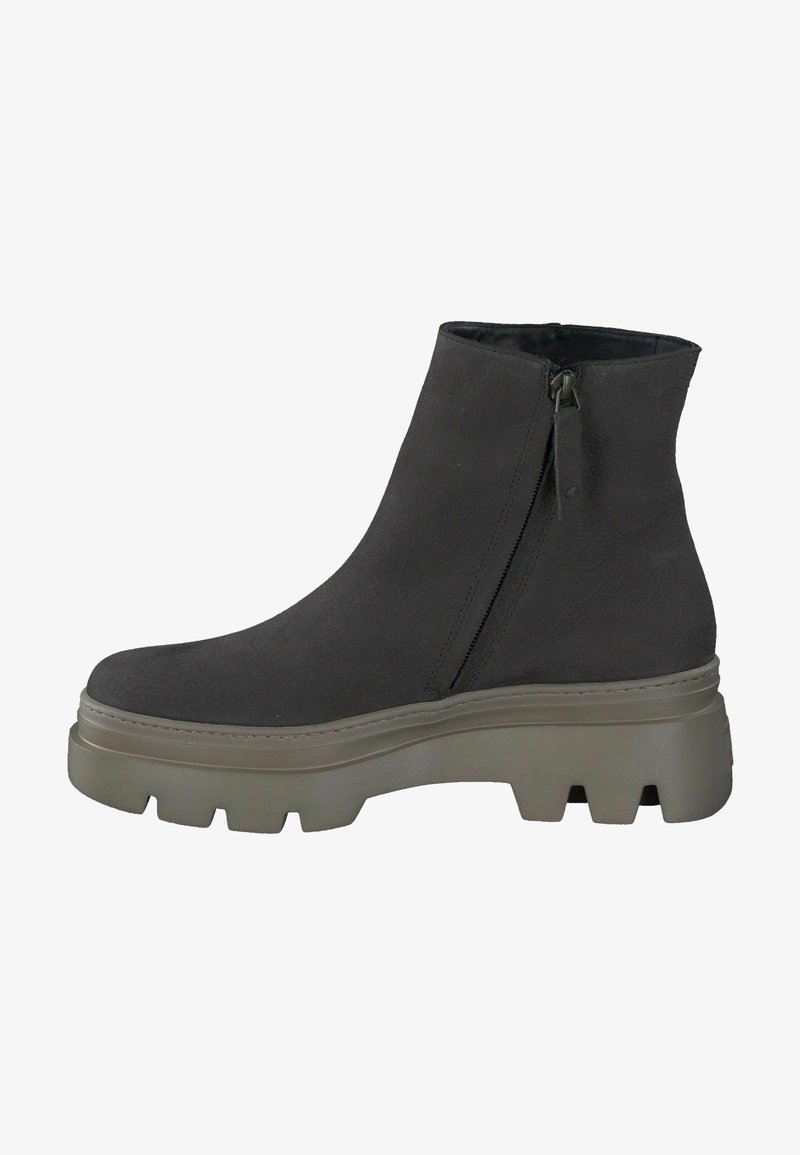 Bottine noire à cheville avec fermeture éclair latérale et semelle épaisse à crampons grise, conçue pour un style robuste et un usage décontracté.