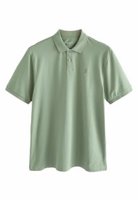 Polo majica u svijetlozelenom pamuku, s ovratnikom, tri gumba i malim logom na prsima. Kratki rukavi s ravnim rubom.
