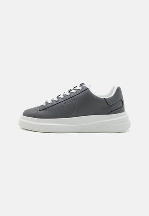 Gray leather sneaker with white sole, round toe, lace-up design, branded side detail, and padded collar for comfort.