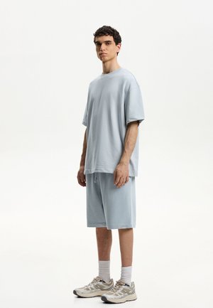 BERMUDA - Tracksuit bottoms - light blue