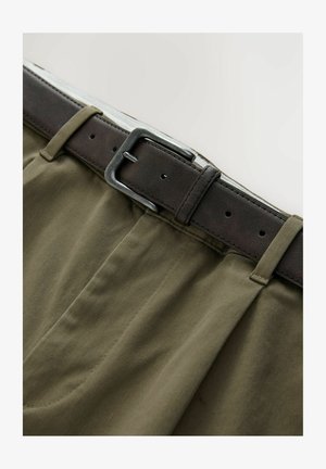 Olive green cotton trousers with a brown leather belt. The belt features a silver metal buckle and loop, with stitched detailing on the fabric.