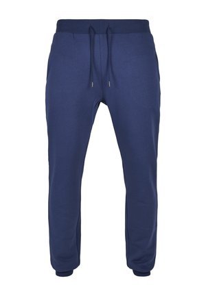 Tamsiai mėlynos spalvos laisvalaikio kelnės iš minkštos medžiagos, su elastine liemene ir raišteliu, bei aptemptais kulkšnies galais formuojantys siaurėjantį siluetą.