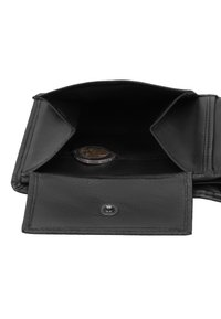 Sort læderpung åben, der viser en tom møntlomme med nogle få mønter indeni, som fremhæver dens opbevaringsfunktion og lukning med trykknap.