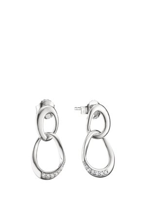 Silver drop earrings with two linked abstract oval shapes, the lower oval featuring small embedded clear stones along the bottom curve.