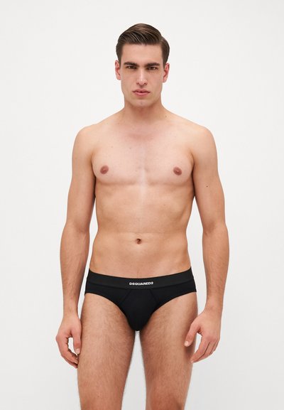 Caleçons noirs pour hommes en tissu extensible, avec une large ceinture portant le logo "DSQUARED2". Le design est ajusté et minimaliste.