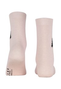 Hellerosa Socken mit gerippten Bündchen, seitlich mit einem schwarzen Baum-Muster. Hergestellt aus weichem Stoff mit glatter Textur.