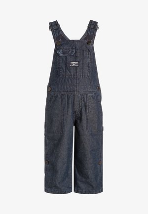 Salopette courte en denim foncé pour enfants avec bretelles réglables, poche poitrine à l'avant et boutons latéraux.