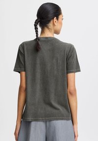Gray cotton t-shirt with short sleeves and crew neck, featuring a slightly relaxed fit and visible stitching along the hem and shoulders.