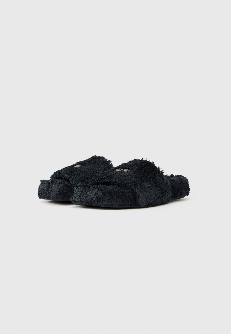 Pair of black fuzzy open-toe slippers with thick sole, shown at slight angle on white background.