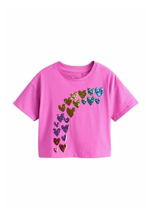 Bright pink short-sleeve t-shirt with multicolored sequined hearts forming an arch on the front left side.