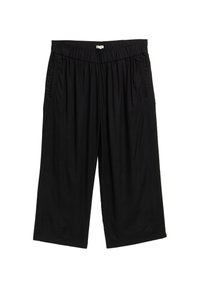 Pantalones culotte negros con cinturilla elástica, que cuentan con bolsillos laterales y una tela suave y ligera. El diseño es holgado.