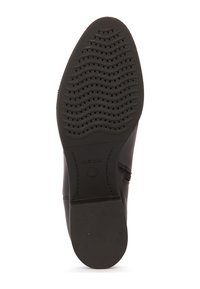 Suola di scarpa in gomma nera con un motivo di battistrada ondulato e perforazioni per la traspirabilità. Branding GEox visibile vicino al tallone.