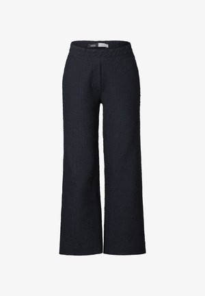 Sorte, tætsiddende bukser med vidde og elastisk talje, samt frynsede detaljer foran, lavet af et vævet stof. Minimalistisk design uden synlig hardware.