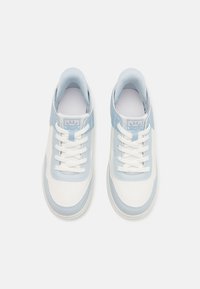 Light blue and white sneakers with a perforated texture, featuring a lace-up design, padded collar, and logo on the tongue.