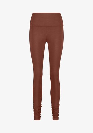 Ruske legsit, joissa on leveä, käännettävä vyötärönauha. Sileä pinta, tiukka muoto ja kerätty yksityiskohta nilkassa.