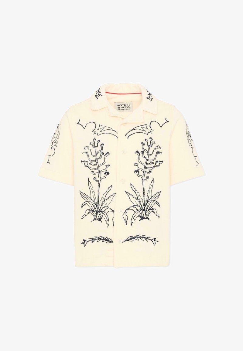 Chemise crème à manches courtes, boutonnée, avec des motifs botaniques brodés en noir sur le devant, les manches et le col, étiquetée Scotch & Soda Amsterdam.