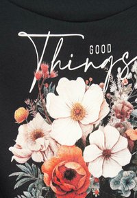 Black fabric features a floral print with peach and white flowers, including anemones and poppies, with "Good Things" text in elegant white script.