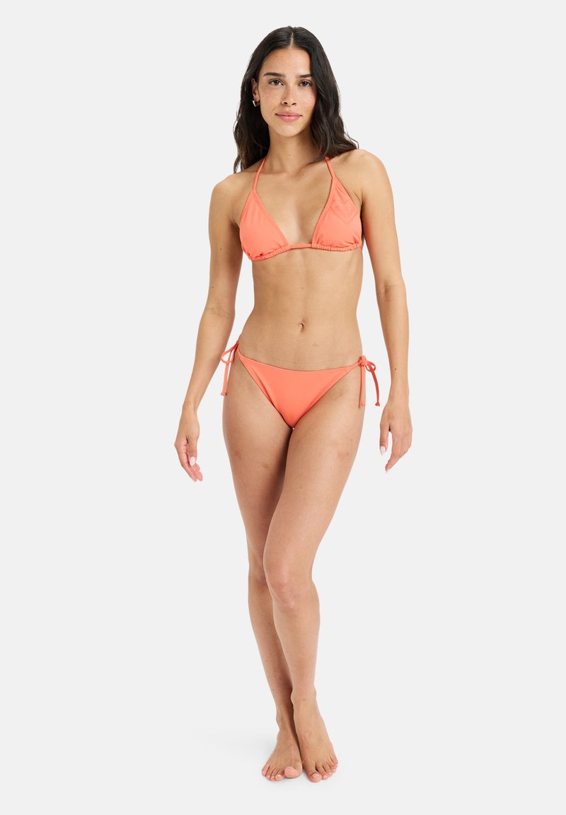 Korall bikini szett háromszög fazonú melltartóval és oldalt kötős alsó résszel. Simább, könnyű anyag. Minimális fém részletek. Testhez álló megjelenésre tervezve.