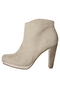 Beige suede ankle boot with a high stiletto heel, rounded toe, and a light-colored platform. Features subtle branding on the side.