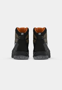 Czarne, wysokie buty outdoorowe z pomarańczowym wykończeniem, teksturowanymi akcentami po bokach i gumowymi podeszwami. Posiadają logo oraz wodoodporne detale.