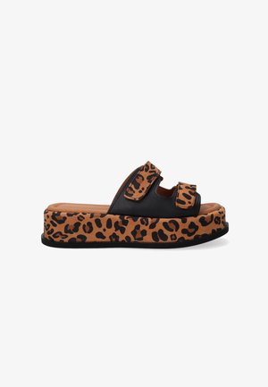 Platform sandals featuring black upper straps and a tan base with a leopard print pattern. Velcro closures on the straps for adjustability.
