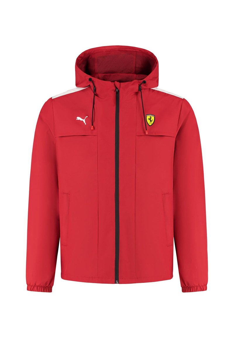 Czerwona kurtka przeciwdeszczowa z kapturem. Posiada białe akcenty, zamek błyskawiczny, kieszenie boczne oraz logo Ferrari na piersi. Wykonana z lekkiego materiału.