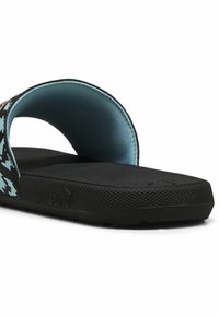 Black slide sandals with an aqua lining. The strap features a patterned design in blue and white. Textured black rubber sole for grip.