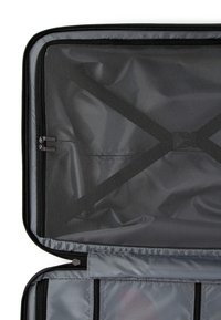 Gray travel bag interior featuring a mesh pocket, black zippers, and organizational straps. Material is smooth and textured, with a lightweight design.