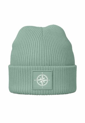 Mint green knit beanie with ribbed texture, folded cuff, and a square patch featuring a compass design in white.