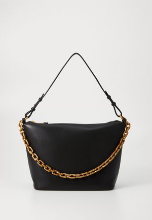 Black leather handbag with a structured shape, featuring a chunky gold chain strap and a detachable thin shoulder strap. Zipper closure.
