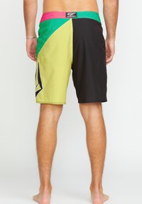Shorts de bain multicolores avec un design jaune, vert, noir et rose, une taille élastique et un petit logo.