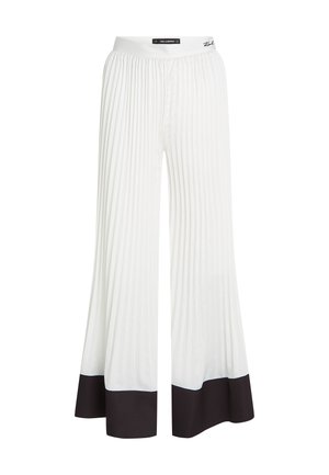 Baltas plīveišās bikses ar platām kājām un melnu apdari gar malām. Izgatavotas no viegla auduma ar elastīgu jostu.