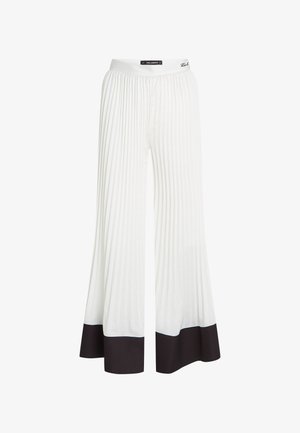 Baltas plīveišās bikses ar platām kājām un melnu apdari gar malām. Izgatavotas no viegla auduma ar elastīgu jostu.