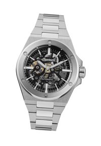 RVS automatische horloge met een zwart skeletuur, zilverkleurige accenten en een schakelband; beschikt over gedurfde uurmarkeringen en wijzers.