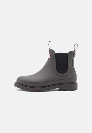 Dark gray rubber ankle boot with elastic side panels and pull tabs, featuring a textured outsole and a smooth finish.