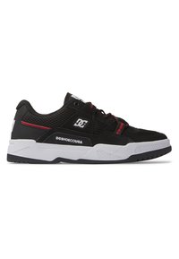 Black sneaker with mesh and synthetic upper, featuring red accents, white sole, and patterned tread. DC logo displayed on the side.