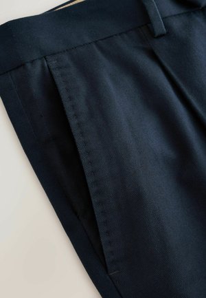 Navy blue fabric trousers with a smooth texture, featuring a straight fit, tidy stitching, and a flat front pocket design.
