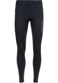 Svarta sportleggings tillverkade av stretchigt material med en mjuk textur, med en reflekterande logotyp på sidan och en figurnära design.