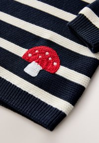 Navy and cream striped knitted sweater featuring an embroidered red mushroom with white spots. Ribbed cuffs and hem.