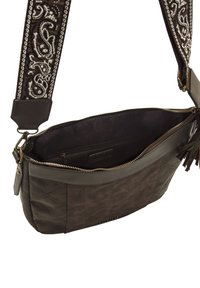 Braune Leder-Crossbody-Tasche mit texturiertem Oberflächen, gestepptem Design und gemustertem Gurt. Reißverschluss oben und sichtbare Innenfächer.