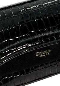 Black patent faux leather clutch with crocodile texture, featuring a gold-tone "Dune London" logo and smooth black fabric accent.