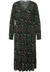 Vestido negro de manga larga con un patrón zigzagueante colorido en verde, rojo y blanco. Cuenta con escote en V y cintura elástica para un ajuste relajado.