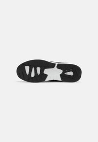 Black and white sneaker sole with a textured rubber surface, featuring a wavy design and several cutouts for enhanced traction.